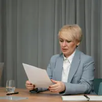 Female mortgage broker at Freedom Capital Solutions office reviewing loan documents
