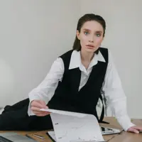 Mortgage broker in formal attire at Freedom Capital Solutions office handing loan document