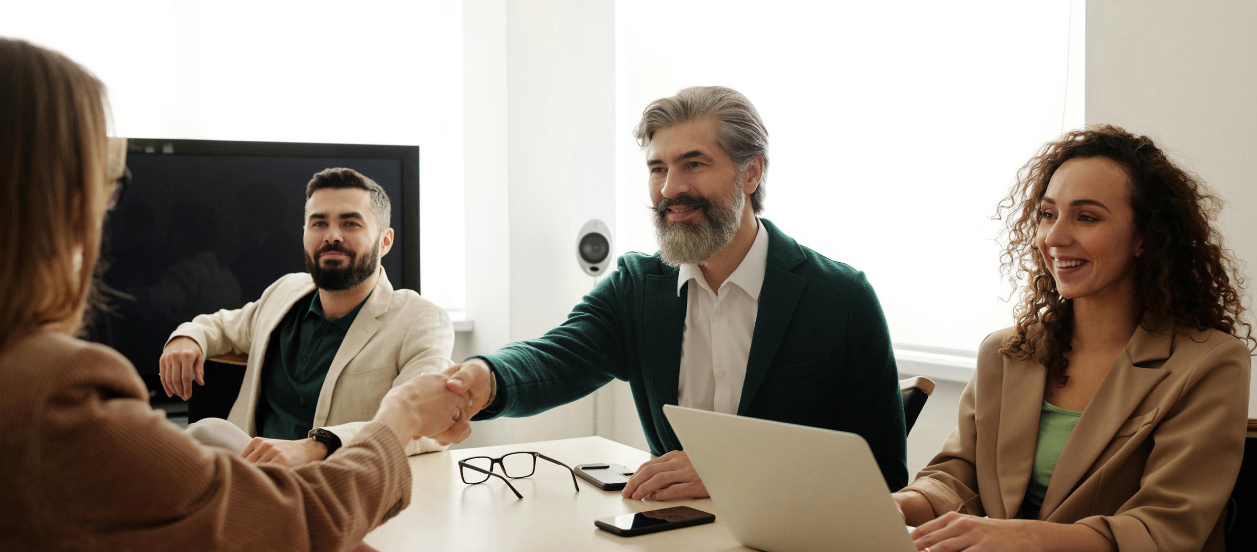 Freedom Capital Solutions brokers shaking hands with client during mortgage consultation